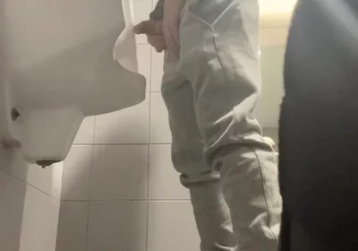 2 Boys in Sneakers Having Fun at Public Toilets' Urinal