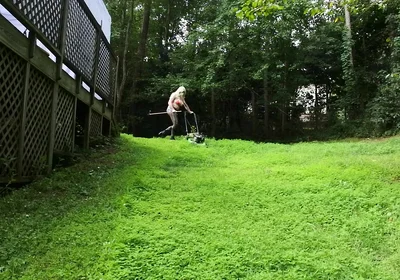 Big Fake Tits Crossdresser in Daisy Dukes Mowing Grass